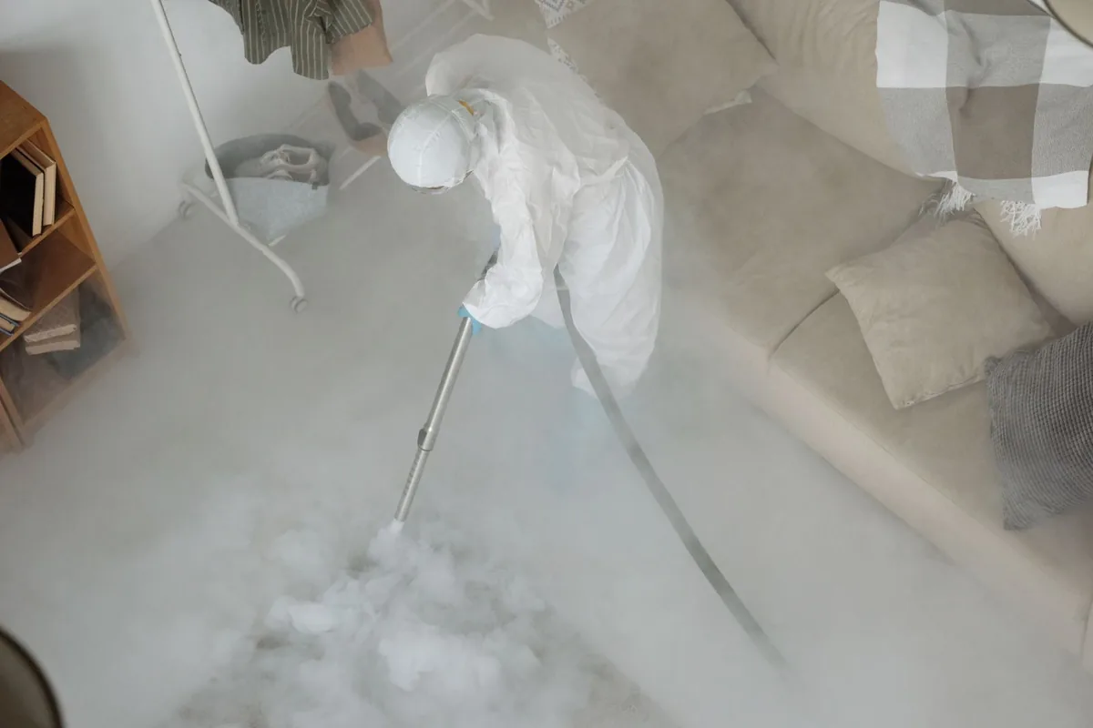 Biohazard cleanup technician in protective equipment, Delshire, OH